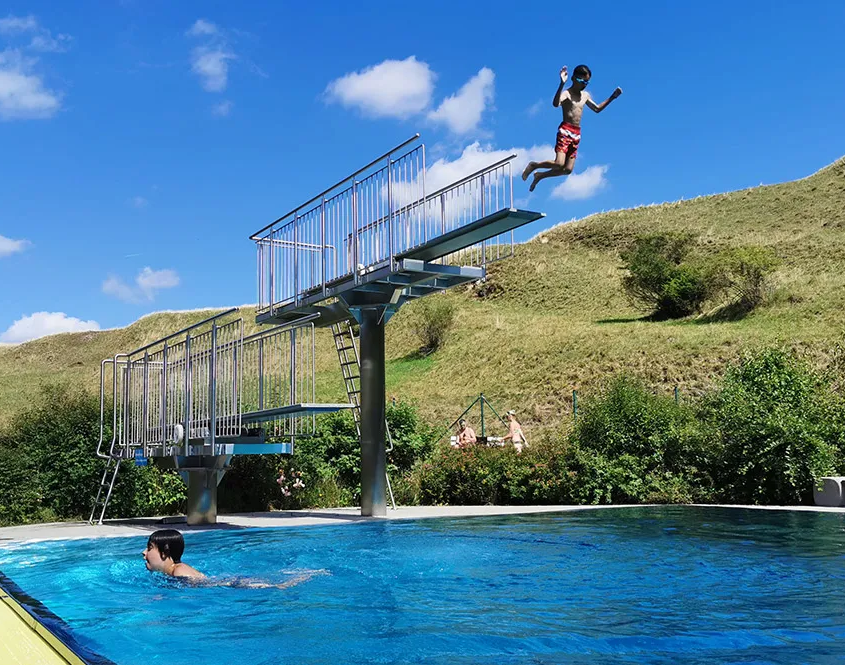 Junge springt vom Sprungturm